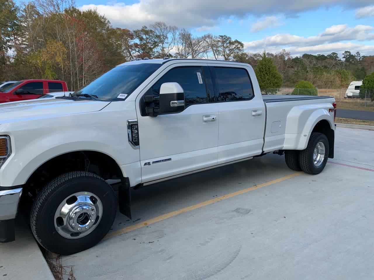 White Ford F-350 dually with professionally tinted windows outside Performance Tinters II